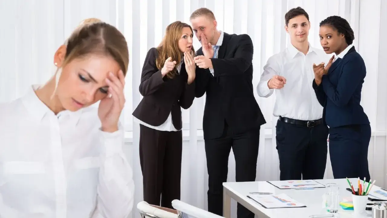 Donna stressata, colleghi che spettegolano e indicano. Come dimostrare il mobbing sul lavoro.