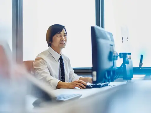 Uomo d'affari al computer, concentrato sul lavoro. Chissà quanto vengono pagati gli straordinari per questo impegno.